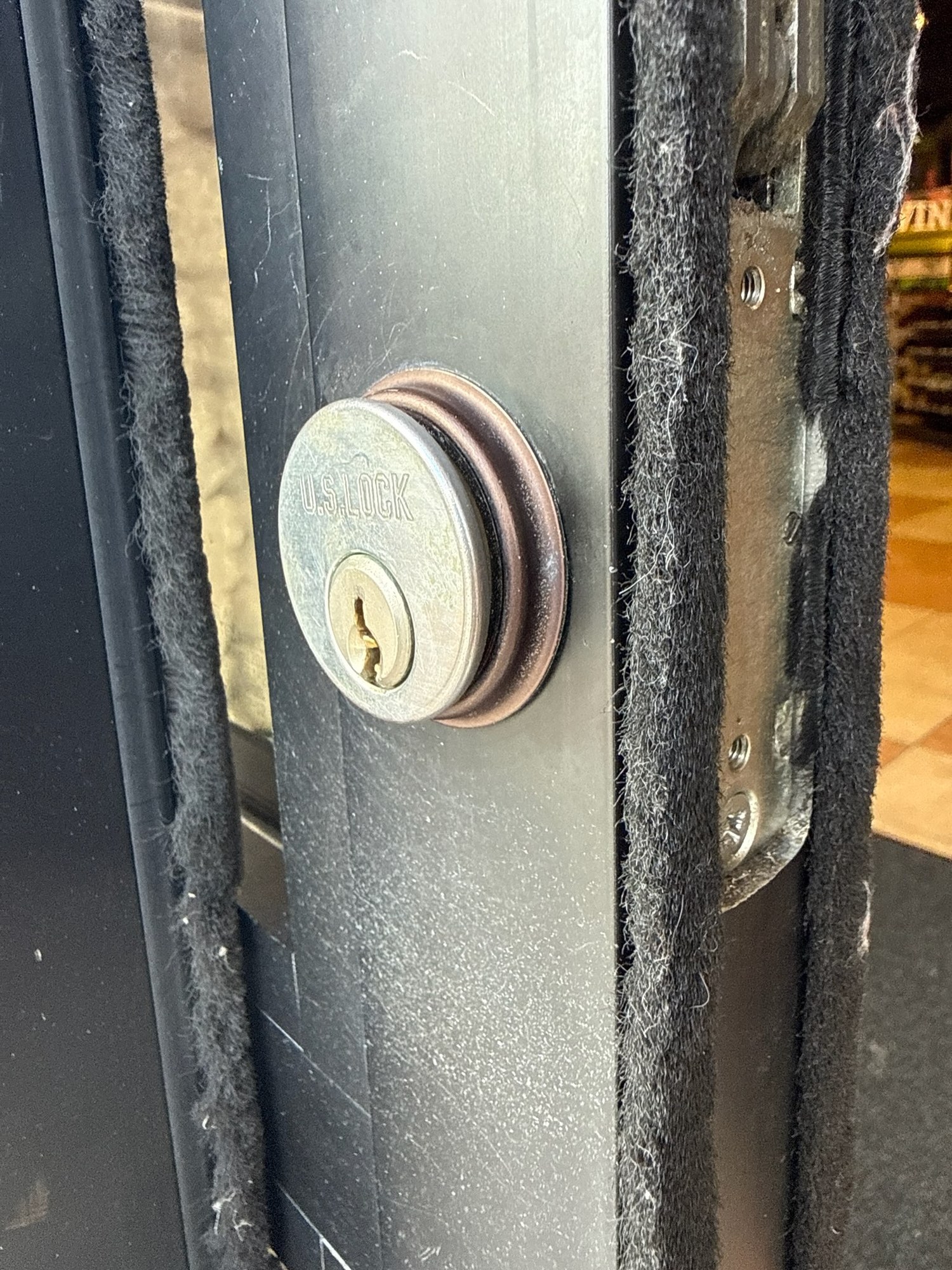 Mortise cylinder rekey on an aluminum storefront door, U.S. Lock